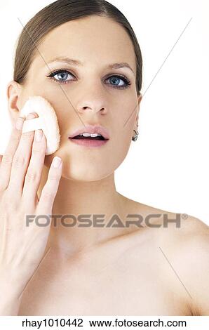 woman applying compact powder on her cheek View Large Photo Image Stock Image - woman applying compact powder on her cheek. Fotosearch