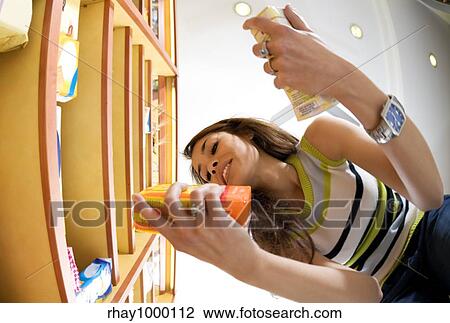 woman in a supermarket reading nutrition information and comparing two products View Large Photo Image Stock Image - woman in a supermarket reading nutrition information and comparing two products. Fotosearch