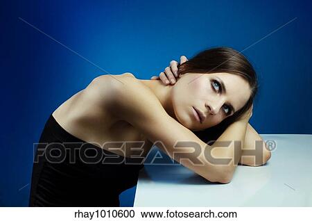 woman resting with her arms on the table View Large Photo Image Stock Image - woman resting with her arms on the table. Fotosearch