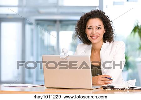 woman sitting at laptop in office View Large Photo Image Stock Photo - woman sitting at laptop in office. Fotosearch