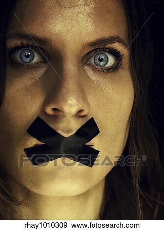 woman's face with covered mouth View Large Photo Image Stock Photo - woman's face with covered mouth. Fotosearch