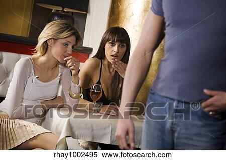 Stock Photography - women admiring man's behind. Fotosearch