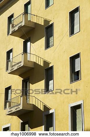 Yellow building facade in the sun View Large Photo Image Stock Photo - Yellow building facade in the sun. Fotosearch