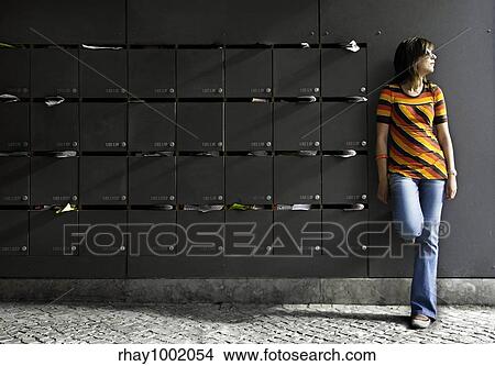 Young and beautiful woman thinking beside mailboxes View Large Photo Image Picture - Young and beautiful woman thinking beside mailboxes. Fotosearch