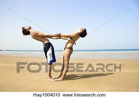 Young couple having fun on the beach View Large Photo Image Stock Image - Young couple having fun on the beach. Fotosearch