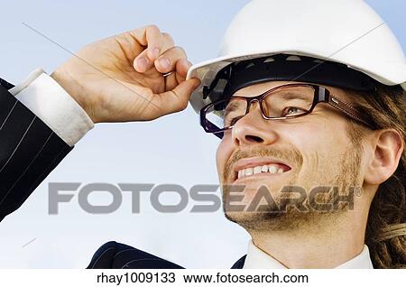 young engineer with dreadlocks in white protective helmet on construction site View Large Photo Image Stock Image - young engineer with dreadlocks in white protective helmet on construction site. Fotosearch