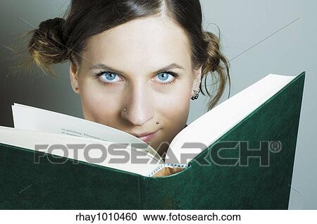 Stock Image - "young girl reading big arse book, probably laws-something". Fotosearch