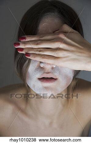 Stock Photo - "young woman covered in white powder( ""see no evil"" expression)". Fotosearch