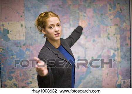 Young woman giving real estate presentation with map View Large Photo Image Stock Image - Young woman giving real estate presentation with map. Fotosearch