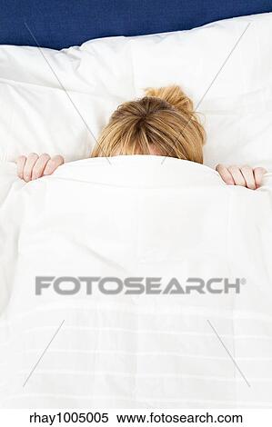 Young woman lying in bed doesn't want to wake up. Copy space View Large Photo Image Stock Photography - Young woman lying in bed doesn't want to wake up. Copy space. Fotosearch