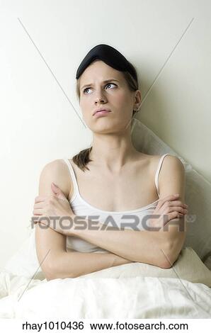 Stock Photograph - young woman trying to get some sleep. Fotosearch