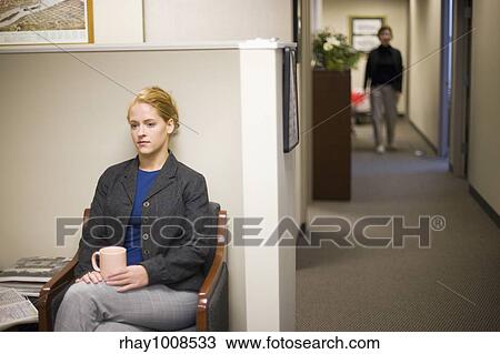 Young woman waiting in office lobby holding coffee cup View Large Photo Image Stock Image - Young woman waiting in office lobby holding coffee cup. Fotosearch