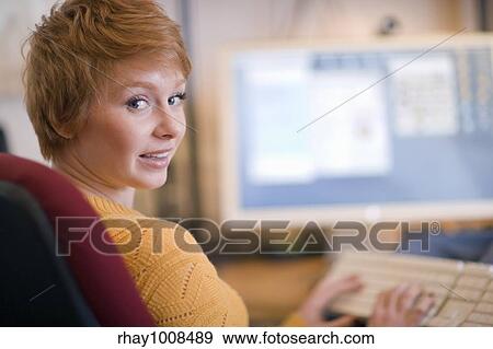 Stock Photo - Young woman working at a computer. Fotosearch