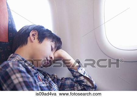 Boy asleep on aeroplane View Large Photo Image Stock Image - Boy asleep on aeroplane. Fotosearch