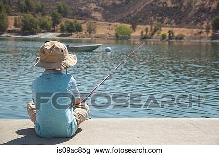 Boy fishing by lake View Large Photo Image Stock Image - Boy fishing by lake. Fotosearch