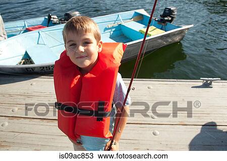 Boy in life jacket posing with fishing rod View Large Photo Image Stock Image - Boy in life jacket posing with fishing rod. Fotosearch