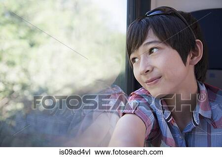 Boy looking out of train window View Large Photo Image Stock Image - Boy looking out of train window. Fotosearch