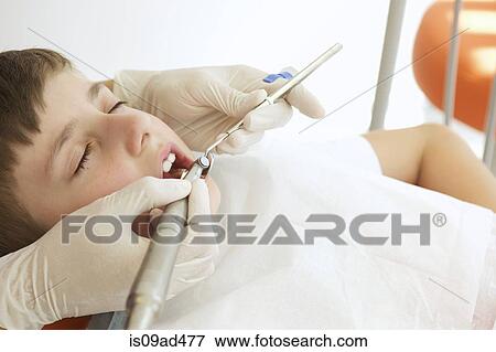 Boy patient receiving dental treatment View Large Photo Image Stock Photo - Boy patient receiving dental treatment. Fotosearch