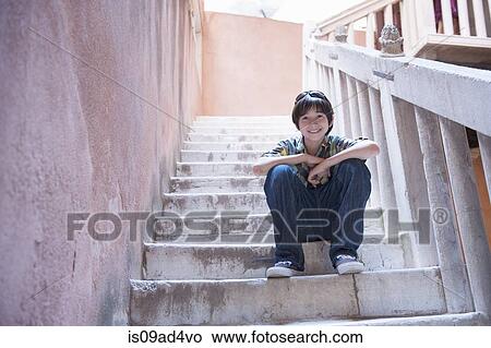 Picture - Boy sitting on steps. Fotosearch