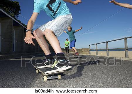 Boys skateboarding View Large Photo Image Stock Image - Boys skateboarding. Fotosearch