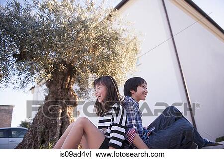 Brother and sister sitting back to back, laughing View Large Photo Image Stock Image - Brother and sister sitting back to back, laughing. Fotosearch