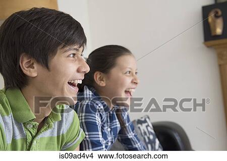 Brother and sister watching tv View Large Photo Image Picture - Brother and sister watching tv. Fotosearch