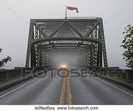 Car emerging from misty bridge View Large Photo Image Stock Image - Car emerging from misty bridge. Fotosearch