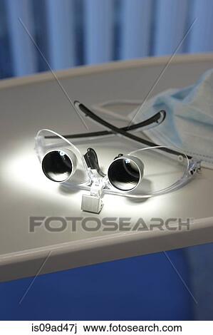 Close up of magnifying glasses and surgical mask in dental office View Large Photo Image Stock Image - Close up of magnifying glasses and surgical mask in dental office. Fotosearch