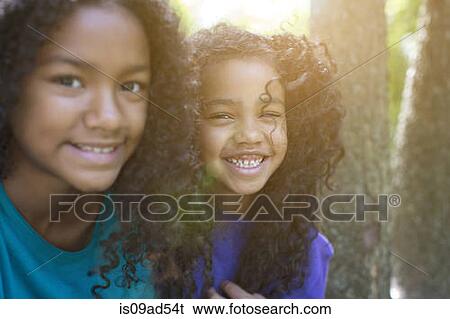Close up portrait of sisters in park View Large Photo Image Stock Photograph - Close up portrait of sisters in park. Fotosearch