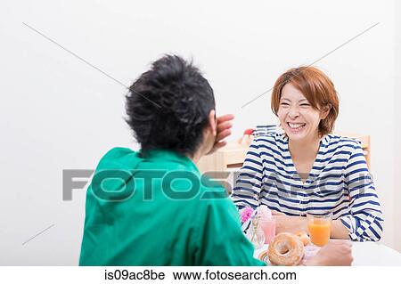 Couple chatting and laughing at coffee break View Large Photo Image Stock Image - Couple chatting and laughing at coffee break. Fotosearch