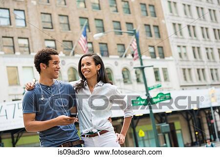 Picture - Couple chatting on street. Fotosearch