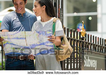 Couple reading map View Large Photo Image Stock Photo - Couple reading map. Fotosearch