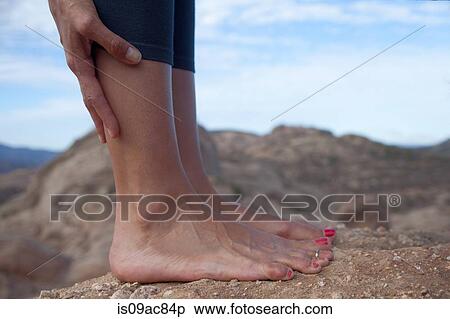 Cropped image of woman's bare feet standing on rocks View Large Photo Image Stock Photography - Cropped image of woman's bare feet standing on rocks. Fotosearch