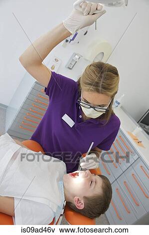 Dentist treating patient View Large Photo Image Stock Photo - Dentist treating patient. Fotosearch