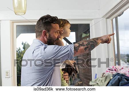 Father and daughter looking through window View Large Photo Image Stock Image - Father and daughter looking through window. Fotosearch