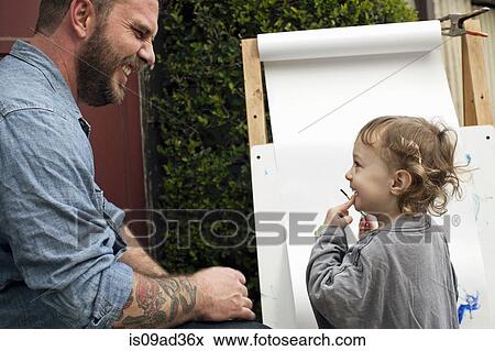 Father and daughters outdoors painting on easel View Large Photo Image Stock Photo - Father and daughters outdoors painting on easel. Fotosearch