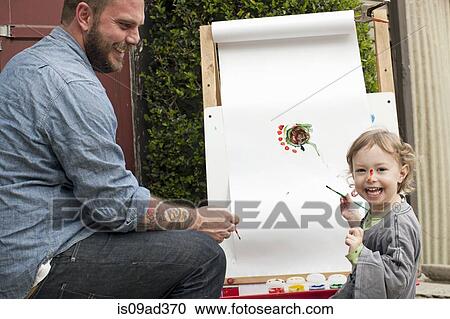 Father fooling around putting paint on daughter's face View Large Photo Image Stock Image - Father fooling around putting paint on daughter's face. Fotosearch