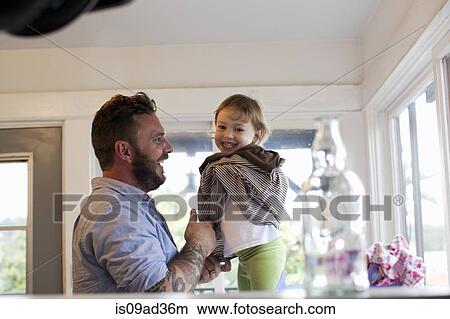 Father getting daughter dressed View Large Photo Image Picture - Father getting daughter dressed. Fotosearch