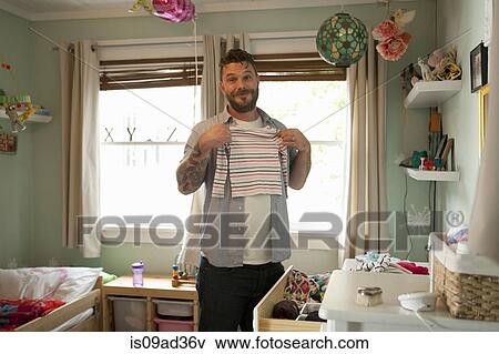 Father putting away child's laundry View Large Photo Image Stock Photo - Father putting away child's laundry. Fotosearch