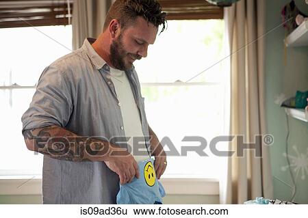 Father putting away child's laundry View Large Photo Image Stock Photograph - Father putting away child's laundry. Fotosearch