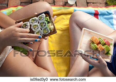 Stock Image - Friends eating sushi. Fotosearch