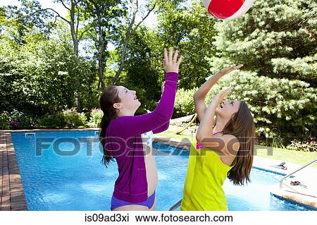 Stock Image - Friends playing by pool. Fotosearch
