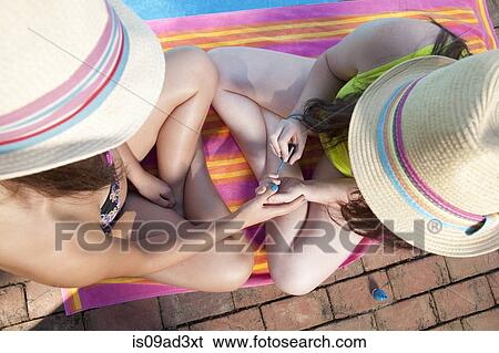 Stock Photograph - Friends playing by pool. Fotosearch