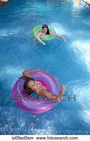 Friends playing in pool View Large Photo Image Picture - Friends playing in pool. Fotosearch