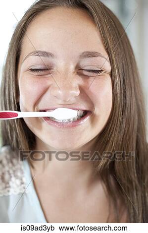 Stock Image - Girl brushing teeth. Fotosearch