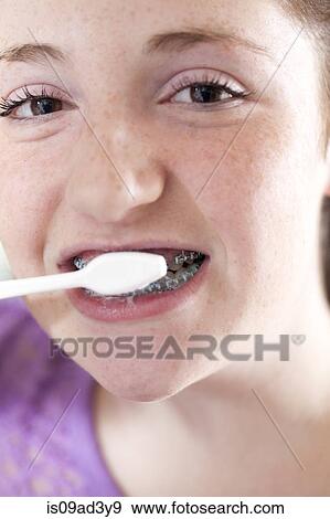 Stock Photo - Girl brushing teeth. Fotosearch