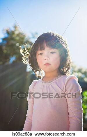 Stock Image - Girl in garden. Fotosearch