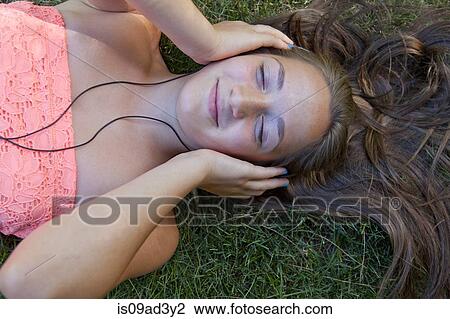 Stock Image - Girl listening to music. Fotosearch