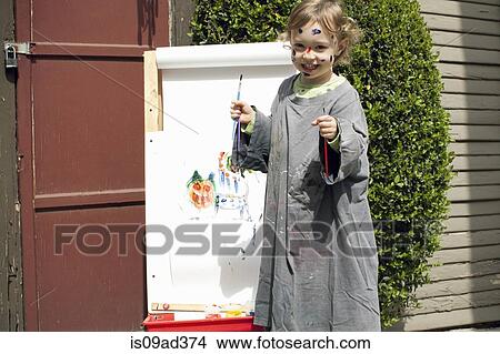 Picture - Girl outdoors painting on easel. Fotosearch