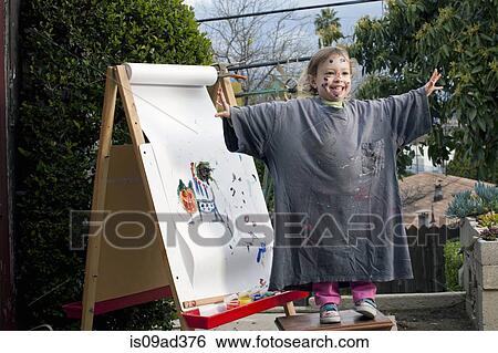 Girl outdoors painting on easel View Large Photo Image Stock Photograph - Girl outdoors painting on easel. Fotosearch